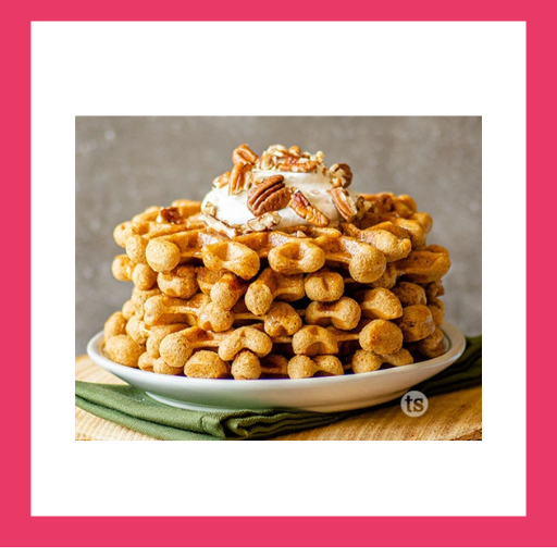Pumpkin waffles topped with whipped cream, pecans and maple syrup, made with Tastefully Simple Pumpkin Bread with Maple Glaze.